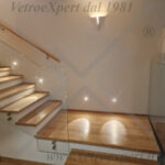 scala interna illuminata con balaustra in vetro elegante